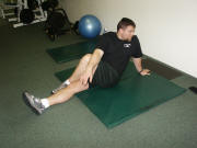 Back Stretching: Seated cross-over leg stretch