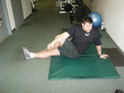 Back Stretching: Seated cross-over leg stretch