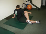Back Stretching: Seated cross-over leg stretch